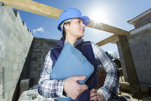 buider woman with clipboard outdoors photo