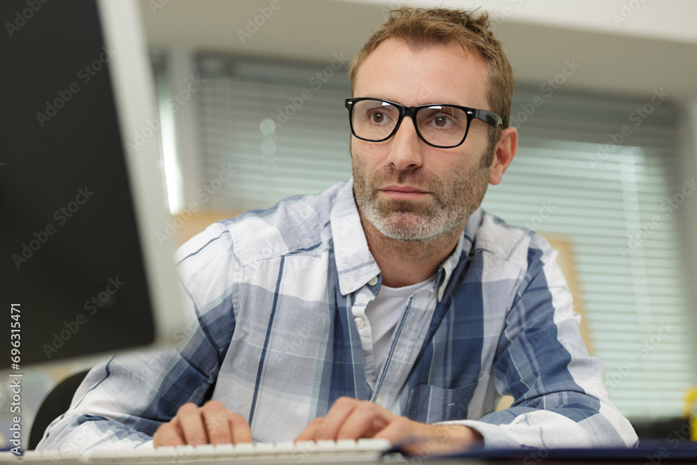 man in glasses working on laptop man in glasses working on laptop