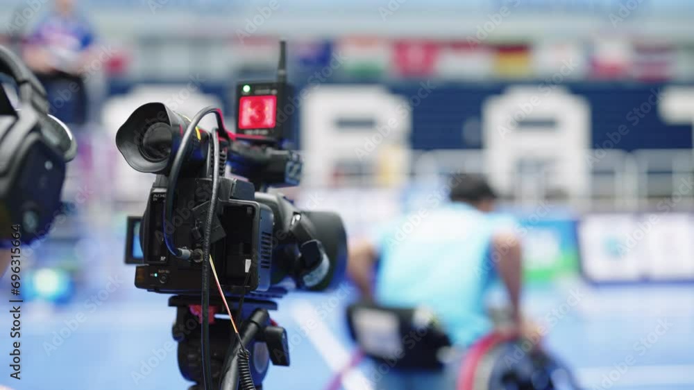 Professional camera with tripod recording Television Operator On TV broadcasting a live media event Professional camera with tripod recording Television Operator On TV broadcasting a live media event