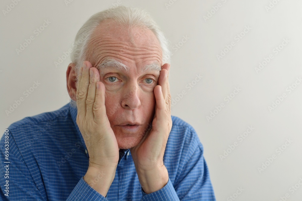 Facial portrait of an elderly gray-haired shocked man with an expressive look stunned by sudden news.
Facial portrait of an elderly gray-haired shocked man with an expressive look stunned by sudden news.