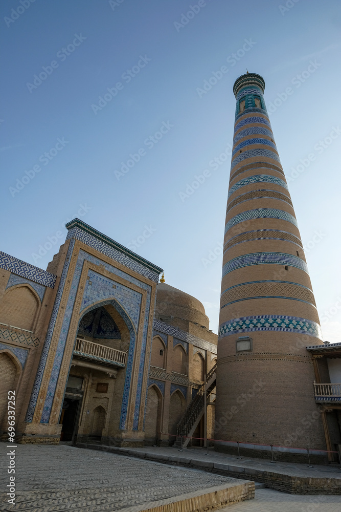 View of the minaret of the Islam Khodja madrasa in the old town of Khiva, Uzbekistan.