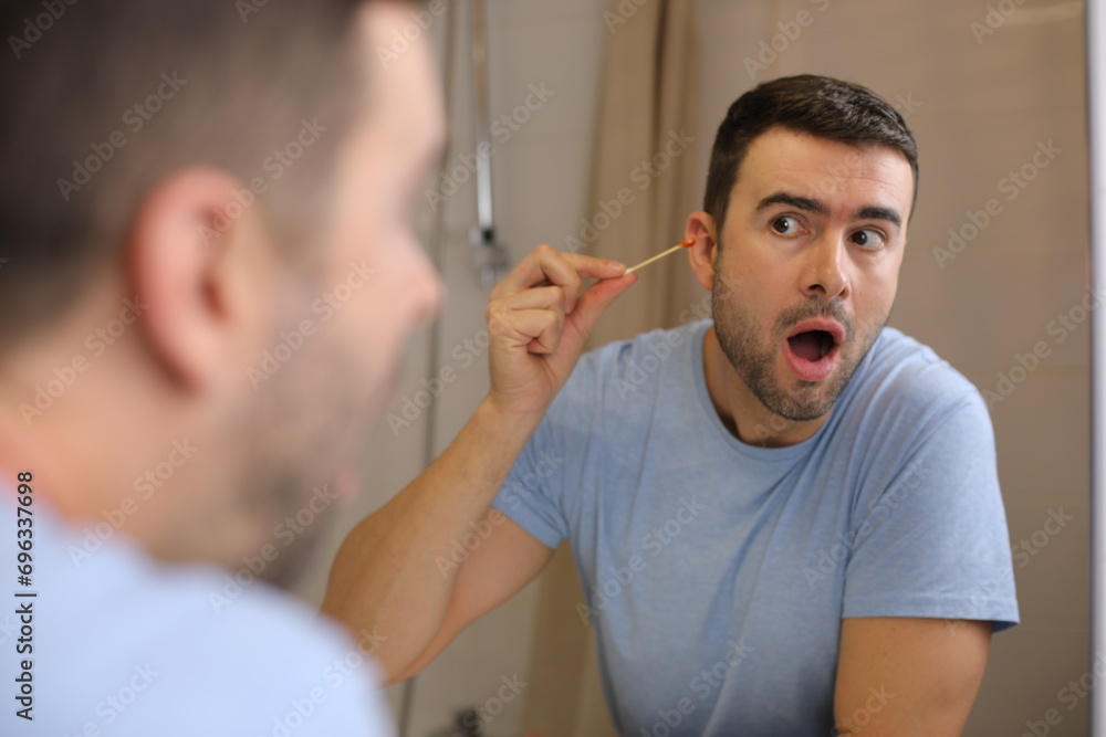 Fototapeta premium Man finding some blood on ear cotton swabs