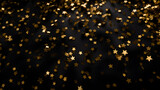 Gold confetti in the shape of stars on a black background