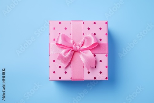 A pink gift box with a bow on a blue background