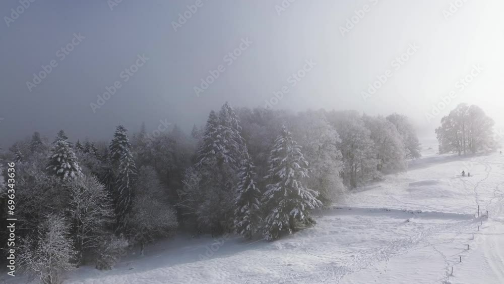Experience the breathtaking Swiss Alps in winter from above. Aerial quadcopter footage captures snow-covered ski trails and majestic vistas, Video of winter with fog Experience the breathtaking Swiss Alps in winter from above. Aerial quadcopter footage captures snow-covered ski trails and majestic vistas, Video of winter with fog