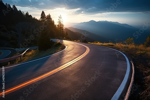Scenic road trip through nature. Asphalt highway winds picturesque landscape surrounded by lush greenery and rolling hills. Warm tones of sunset cast golden glow over scene creating serene © Wuttichai