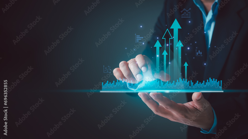 Business development concepts for success and growth, Businessman taps finger on tablet to display a graph with arrow sign for the future growth plan of organization. finance, management, strategy. - obrazy, fototapety, plakaty 
