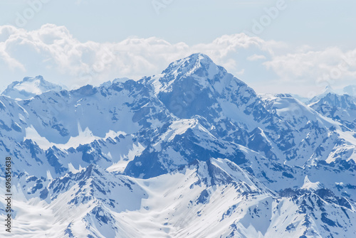 Snow-covered winter mountains of the Caucasus on a sunny day. Panoramic view from the ski slope of Elbrus  Kabardino-Balkaria  Russia