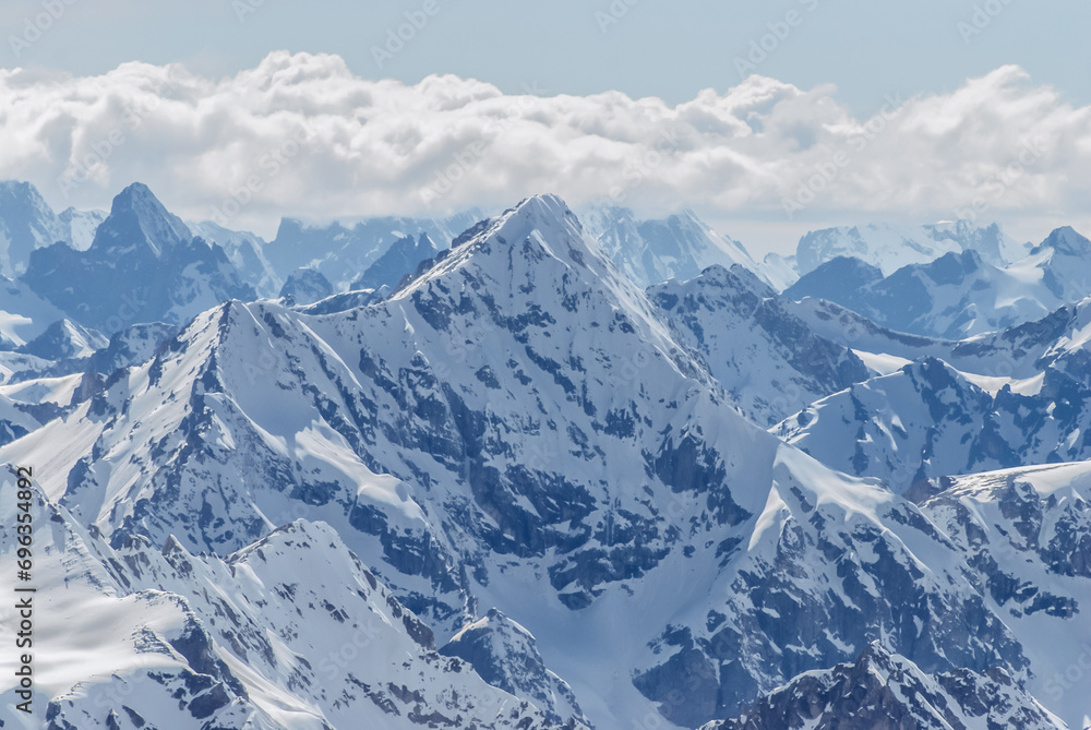Obraz premium Snow-covered winter mountains of the Caucasus on a sunny day. Panoramic view from the ski slope of Elbrus, Kabardino-Balkaria, Russia