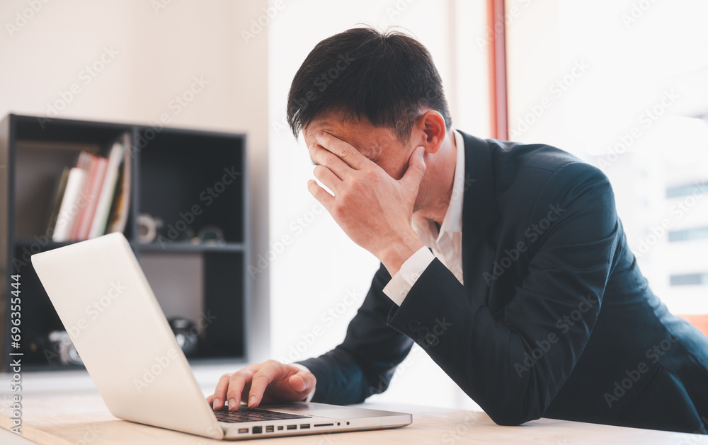 man having stressful time working on laptop headache and multitask with business man in office for deadline, burnout and overworked man having stressful time working on laptop headache and multitask with business man in office for deadline, burnout and overworked
