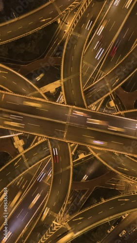 Yan'An Elevated Road Overpass at Night. Shanghai City. China. Aerial Top-Down Hyper Lapse, Time Lapse. Drone Flies Upwards and Rotates. Vertical Video