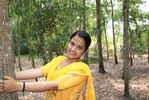 Asian Indian teenage girl in yellow dress, A girl against the nature background.