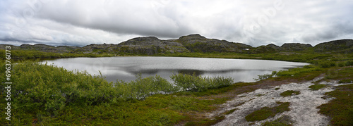 Northern landscape with a lake and tundra surrounded by hills on the Kola Peninsula photo