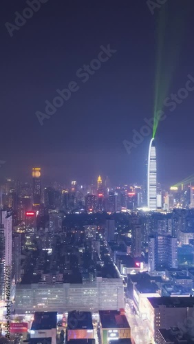 Shenzhen City at Night. Futian and Luohu District. China. Aerial Hyper Lapse, Time Lapse. Drone Flies Sideways and Upwards. Vertical Video photo