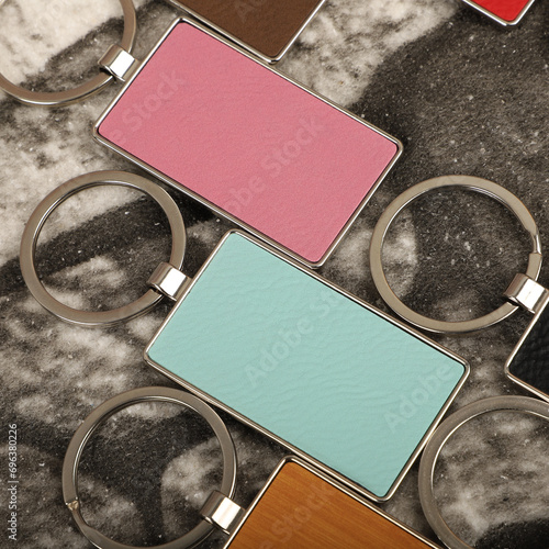 Metal and leather keychains. Colorful one side leather; Square, rectangle and circle shaped key rings. Concept shots, photos taken specially for e-commerce sales. photo