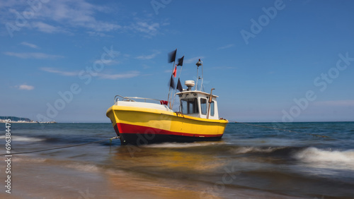 Fishing boat on the beach in Sopot, Poland. Magnificent long exposure calm Baltic Sea. Wallpaper defocused waves. Fishermans sea bay Vacation and holidays. travel attraction tourist destination 