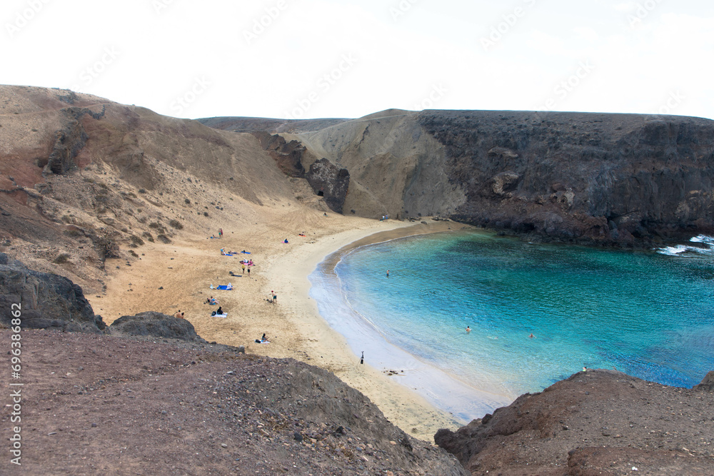 Panoramic view of the natural sandy beach of Papagayo on Lanzarote in a volcanic landscape in Los Ajaches National Park. Playa Blanca, Lanzarote, Spain