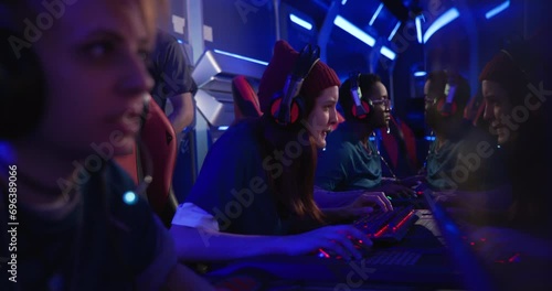 Professional female gaming team winning match at tournament arena