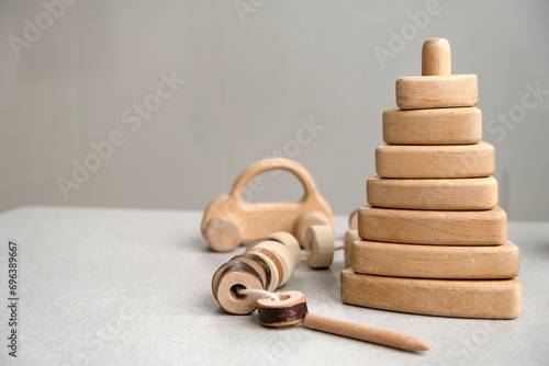 Eco friendly plastic free toys. Modern wooden toys: pyramid, car, lacing toy. Motor skills development. Toys for Montessori educational games. Eco friendly wooden toys. Non plastic childhood. photo