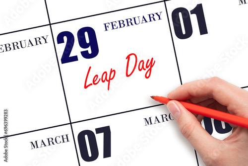 February 29. Hand writing text Leap Day on calendar date. Save the date. photo