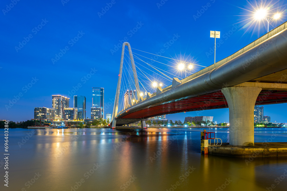 Landscape of Ba Son cable-stayed bridge spanning the Saigon River at night in Ho Chi Minh City, Vietnam.
