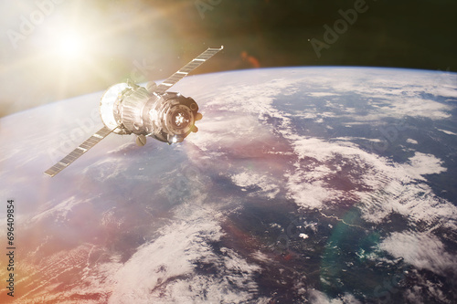 Fototapeta Naklejka Na Ścianę i Meble -  Satellite launch into space on Earth background. Elements of this image furnished by NASA.