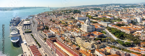 Aerial view of Lisbon city center. View of National Pantheon at right. Spectacular cruise ships moored in the port. Rooftops of Lisbon. Famous European travel destination and capital of Portugal.
