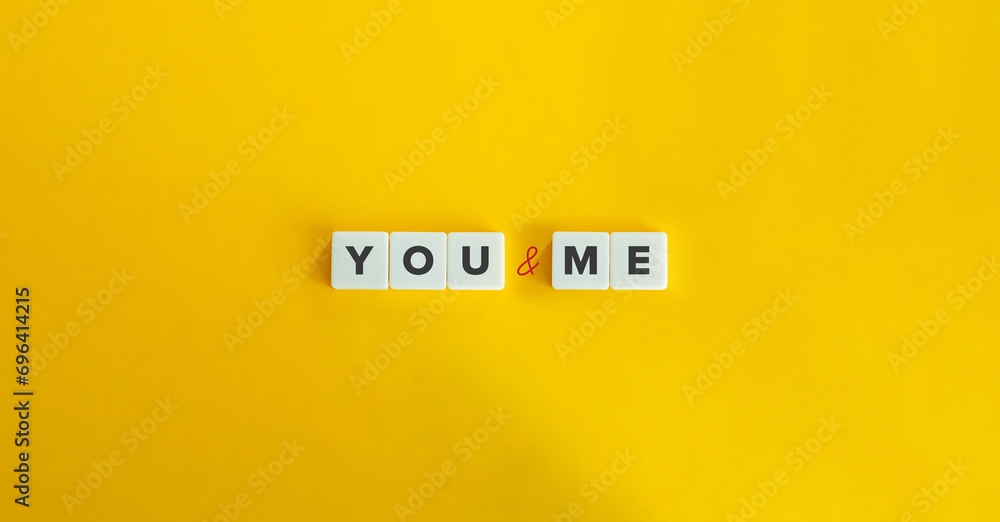 You and Me Text on Block Letter Tiles on Yellow Background. Minimalist Aesthetics.