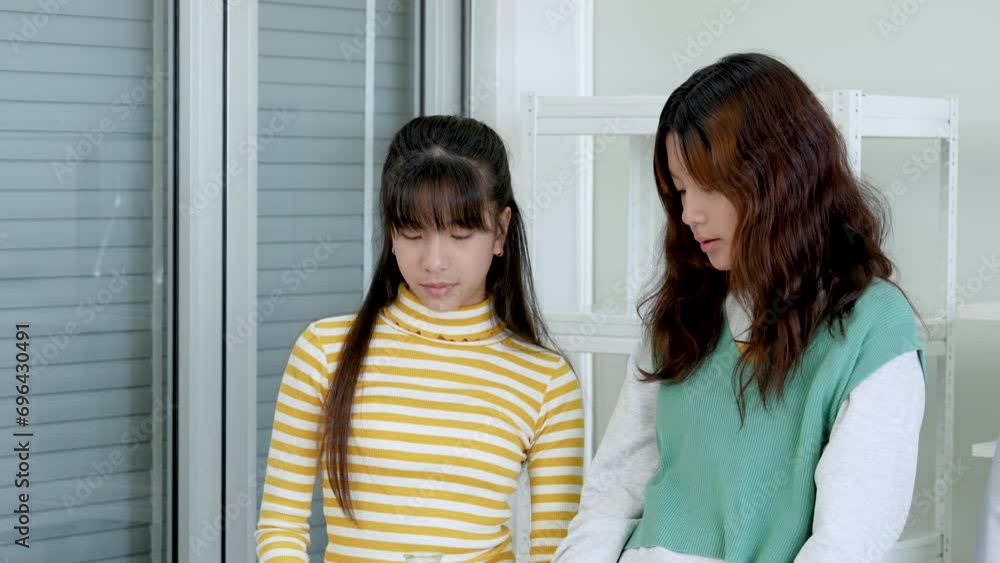 An Asian girls student kid enjoy study, learn, participate on test tube and microscope in lab or laboratory in classroom, medical, chemistry. Experiment science. Education in classroom. Learning lifes