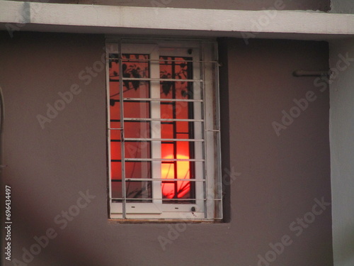Sun reflection in Glass Window in House Sun set in mirror