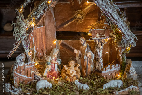 Beautiful Christmas nativity scene with holy family in a handmade wooden old stable, Italian traditional Presepio or Presepe