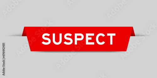 Red color inserted label with word suspect on gray background photo