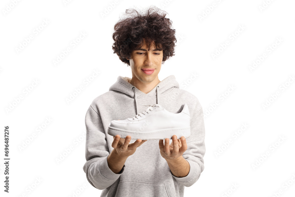 Guy looking at a white sneaker Guy looking at a white sneaker
