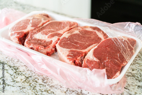 Unpacking Rib Eye Steak in Modern Kitchen photo