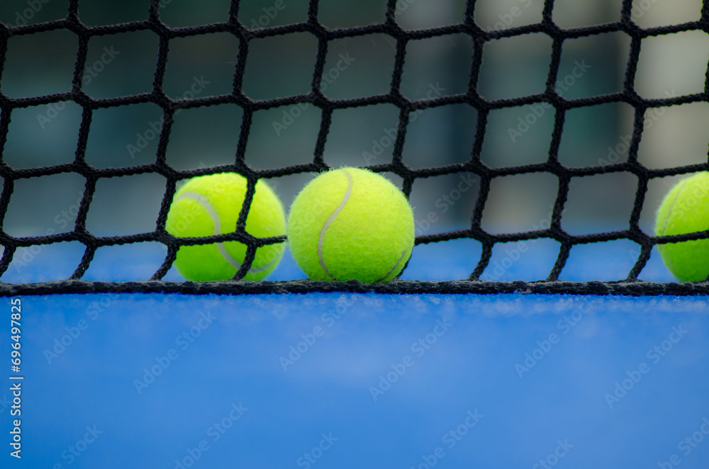 selective focus, two balls and the net of a paddle tennis court