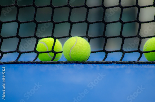 selective focus, two balls and the net of a paddle tennis court © Vic