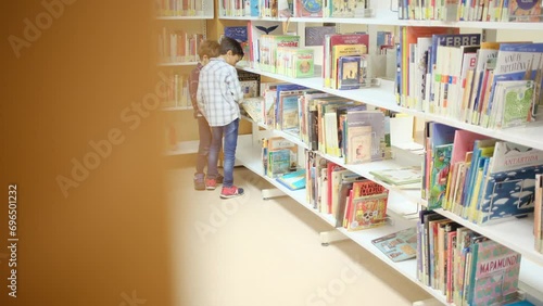 A child in the bookstore publishes with books. concept of education, imagination and public library. Share discoveries in childhood. Stimulate children's image, education and interest in science. photo