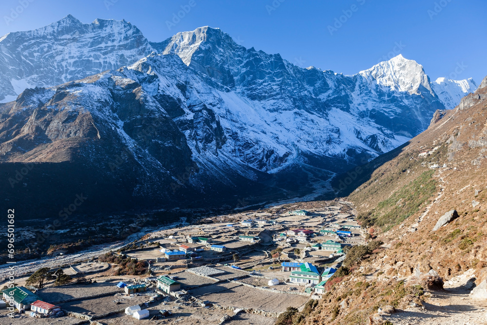 Thame village on sunny day. Himalayan village in Nepal. Settlement on Everest Base Camp Trek. View from the trail.