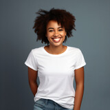 Laughing woman with afro in a white shirt in front of a clean background