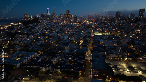 panoramic aerial night view of greater San Francisco area with illuminated skyline of SoMa and Financial District  in the background