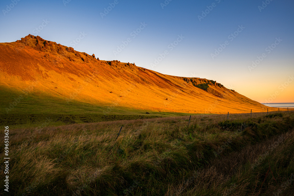 Icelandic sunset over the golden fields, close to the town of Vik.