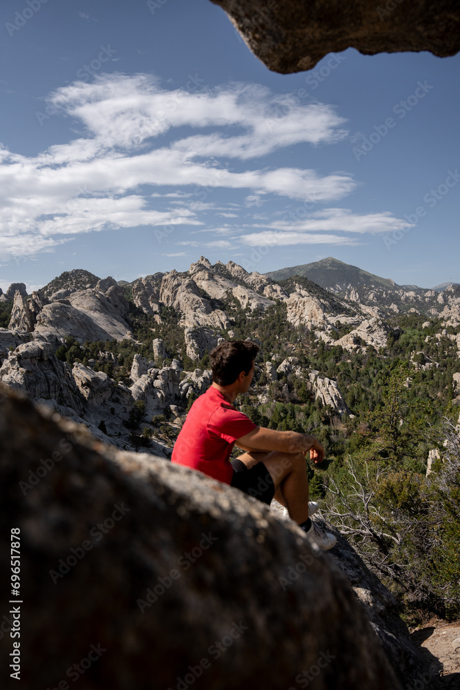 Man in red shirt visiting the City of Rocks National Reserve in Idaho, United States. Man in red shirt visiting the City of Rocks National Reserve in Idaho, United States.