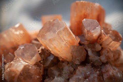 Orange aragonite crystal. Close-up raw rough unpolished semi-precious gemstone photo