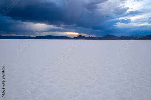 Aerial of Utah Bonneville Salt Flats with cloudy skies.  Shot on a drone.  Blue cracked salt flat near Salt Lake City  Utah in the western part of the United States.