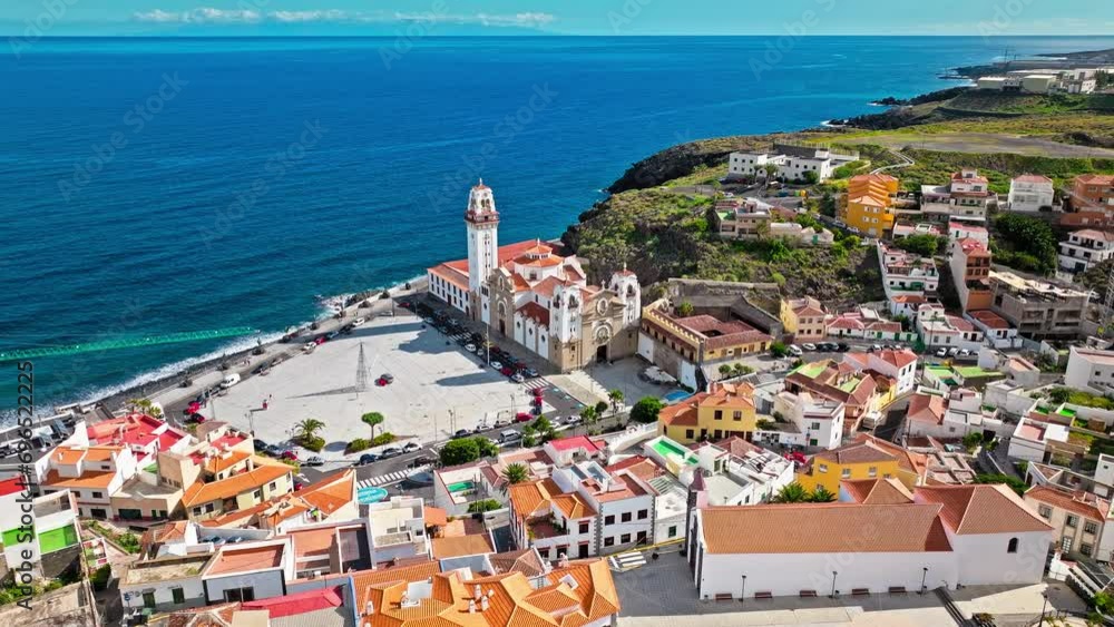 Aerial view of Roman Catholic Spanish Church and colourful houses, and hotels in the Canary Islands, Spain. View from above of Basilica of Our Lady of Candelaria by the seashore in Tenerife. Aerial view of Roman Catholic Spanish Church and colourful houses, and hotels in the Canary Islands, Spain. View from above of Basilica of Our Lady of Candelaria by the seashore in Tenerife.
