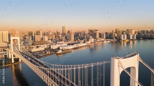tokyo city cityscape aerial view drone of rainbow bridge shot at sunrise dawn,modern town waterfront with skyscrapers in the background photo