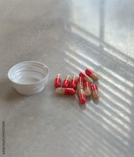 pills lumped together on white desk adderall 30mg addiction bottle in home office photo