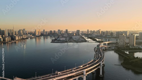 tokyo city rainbow bridge aerial view drone,traffic on highway street crossing the sea bay kotoku district in the background from odaiba ward at sunrise dawn photo