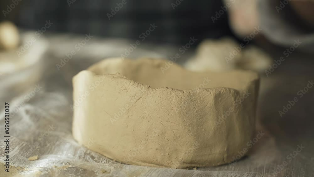 A woman makes a clay product with her hands - a ceramic pot. Close-up. Creative hobby. A woman makes a clay product with her hands - a ceramic pot. Close-up. Creative hobby.