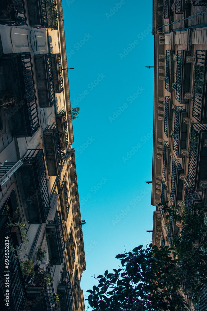 Naklejka premium Historical building on Rambla street cityscape image. Aerial street view at sunset time in Barcelona, Spain photo.